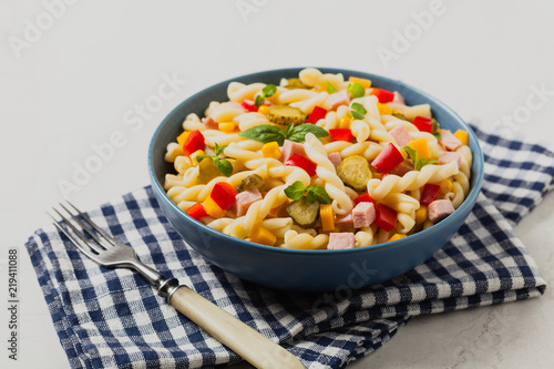 Italian fusilli pasta in a salad with ham and vegetables.