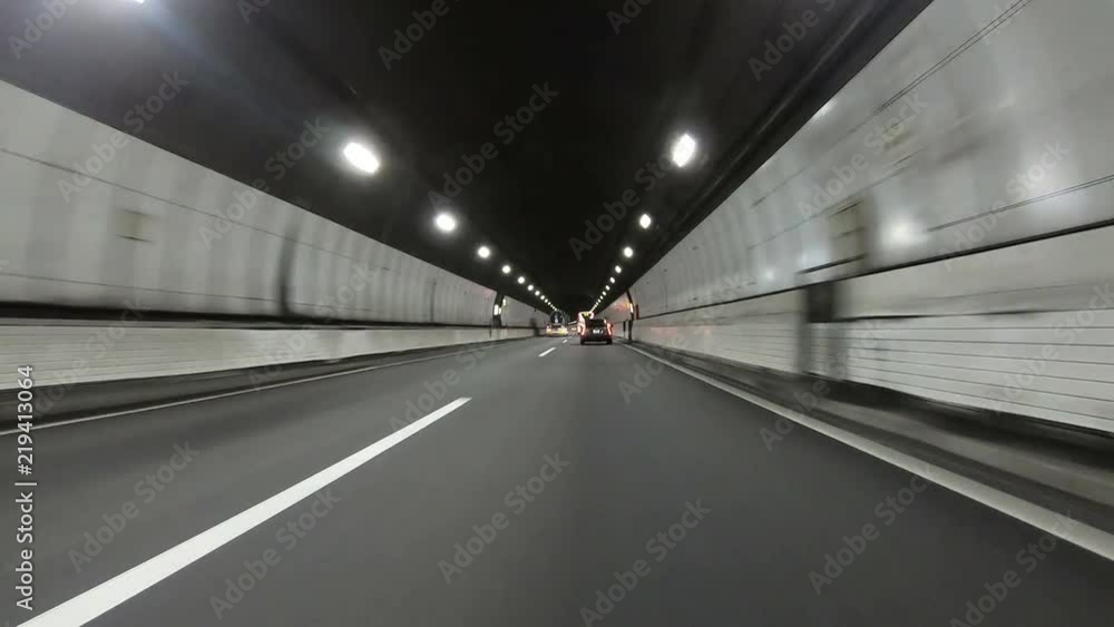 Point of view on car driving through tunnel