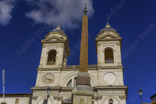 Rome Italy Santissima Trinita dei Monti church at Spanish Steps. Day view of Roman Catholic titular church facade with bell towers and obelisk above Piazza di Spagna.