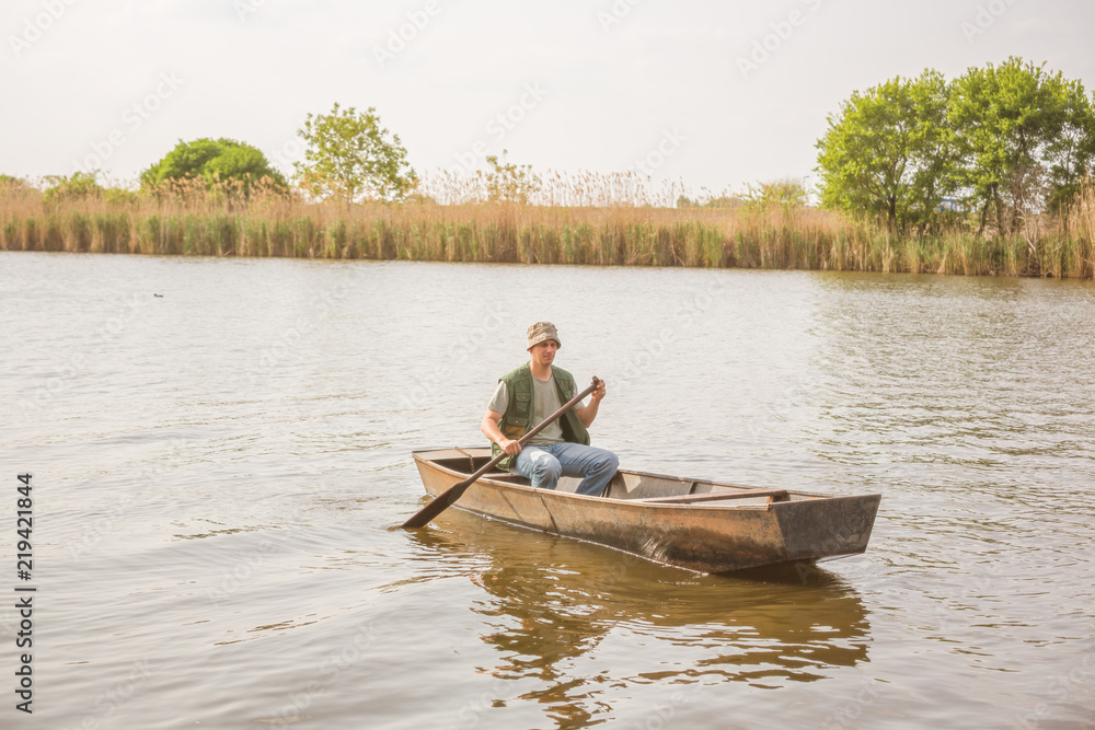 man fishing on a lake- Fisherman in fishing boat .