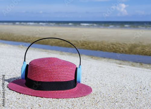 Beautiful women's hat on the beach during summer.