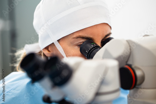 Doctor using microscope during eye surgery process, treatment of cataract and diopter correction. Medical healthcare and technology theme.