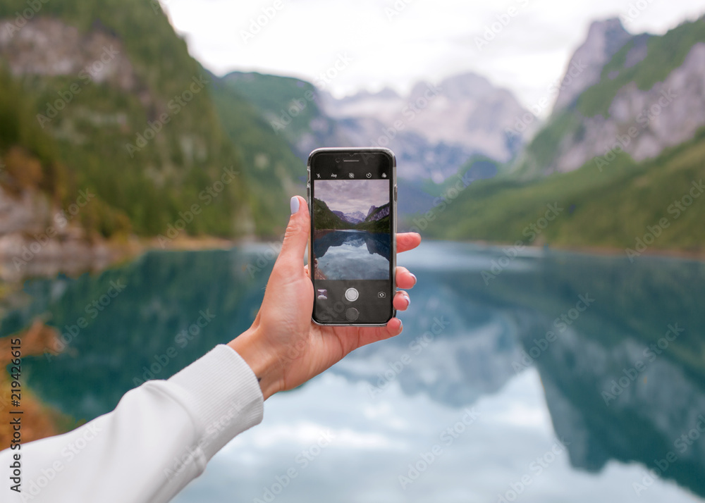 Smartphone in hand, photographing nature
