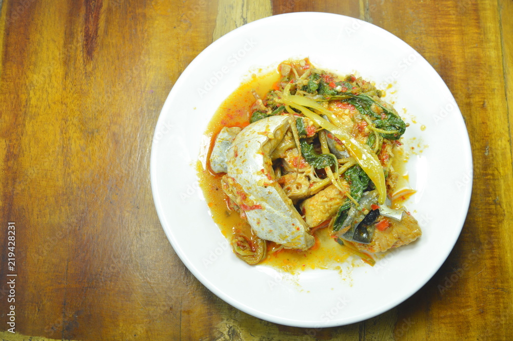 spicy fried striped catfish with herb and curry on plate