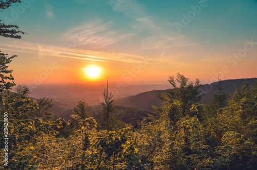 Beautiful mountain landscape. Sunset over the hills and cities.