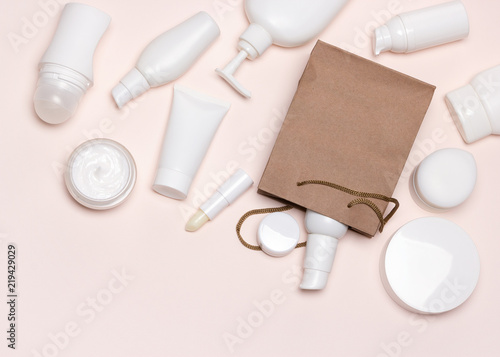Various cosmetics and paper merchandise bag flatlay