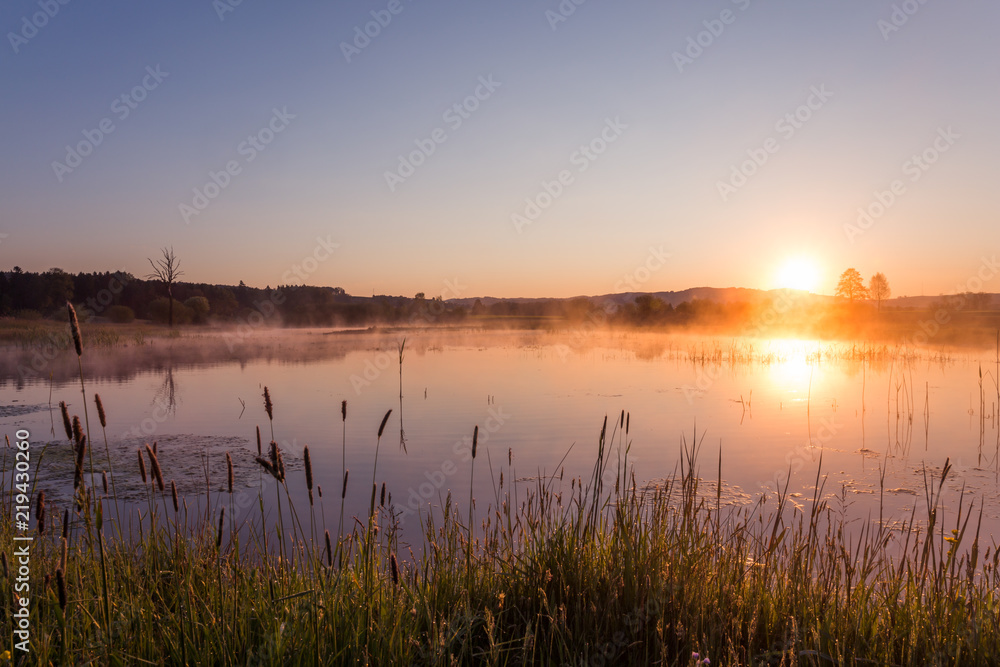 Misty Golden Sunrise Reflecting over Lake in Spring. Misty Golden Sunrise Reflecting over Lake in Spring.
