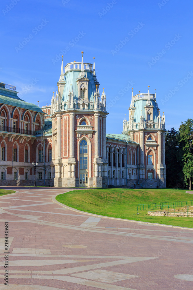 Towers of Great Palace in Museum-reserve Tsaritsyno in Moscow against blue sky and footpaths on a sunny summer morning