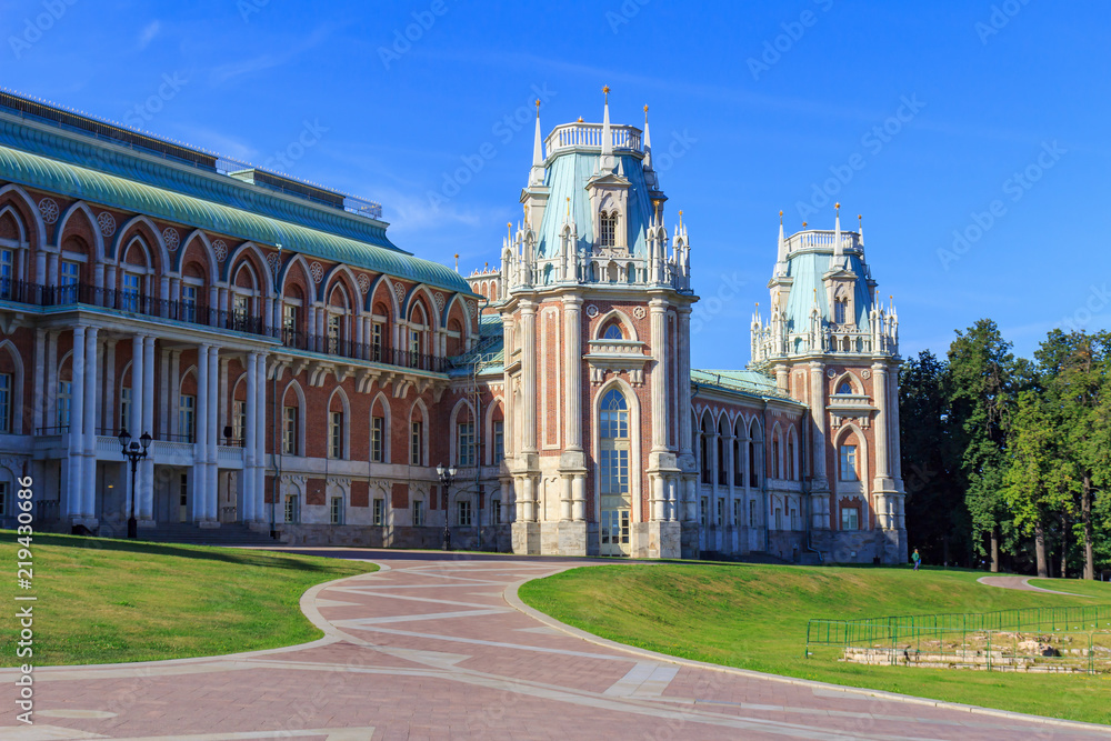 Great Palace in Museum-reserve Tsaritsyno in Moscow against green lawn with footpaths on a sunny summer morning