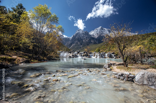 Blue lake in the Himalayas tibet mountains with trees and blue sky in China at autumn