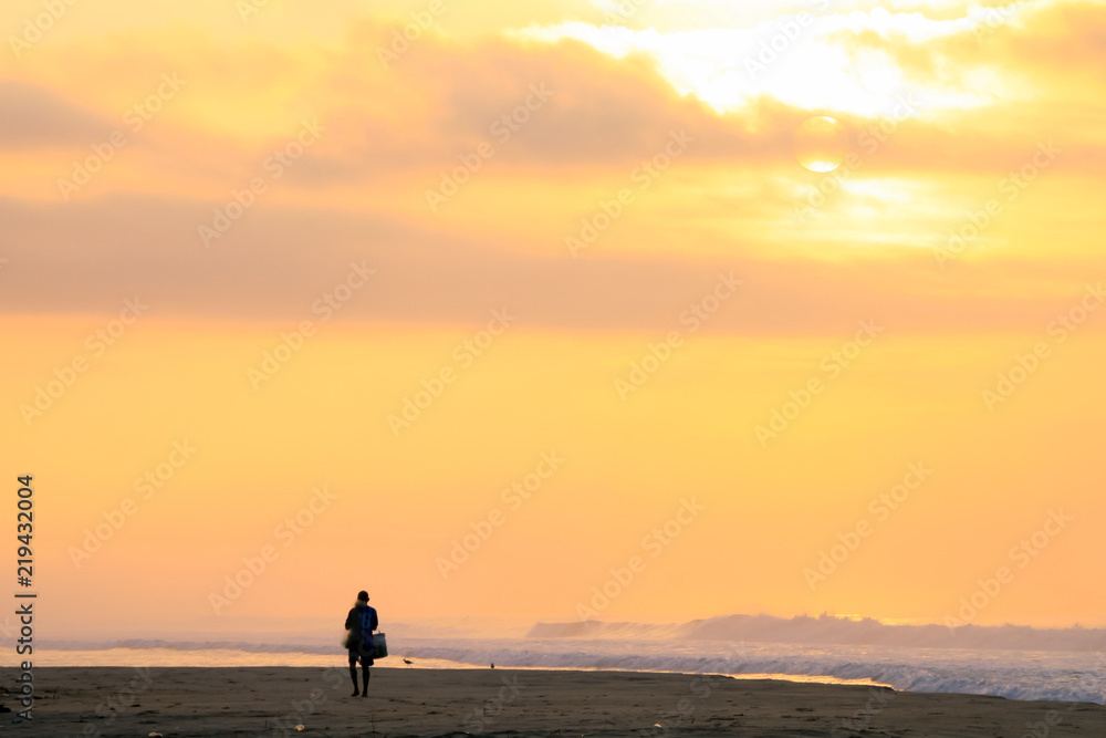 Mexican Fisherman Walking on Pacific Ocean Beach at Sunrise.
