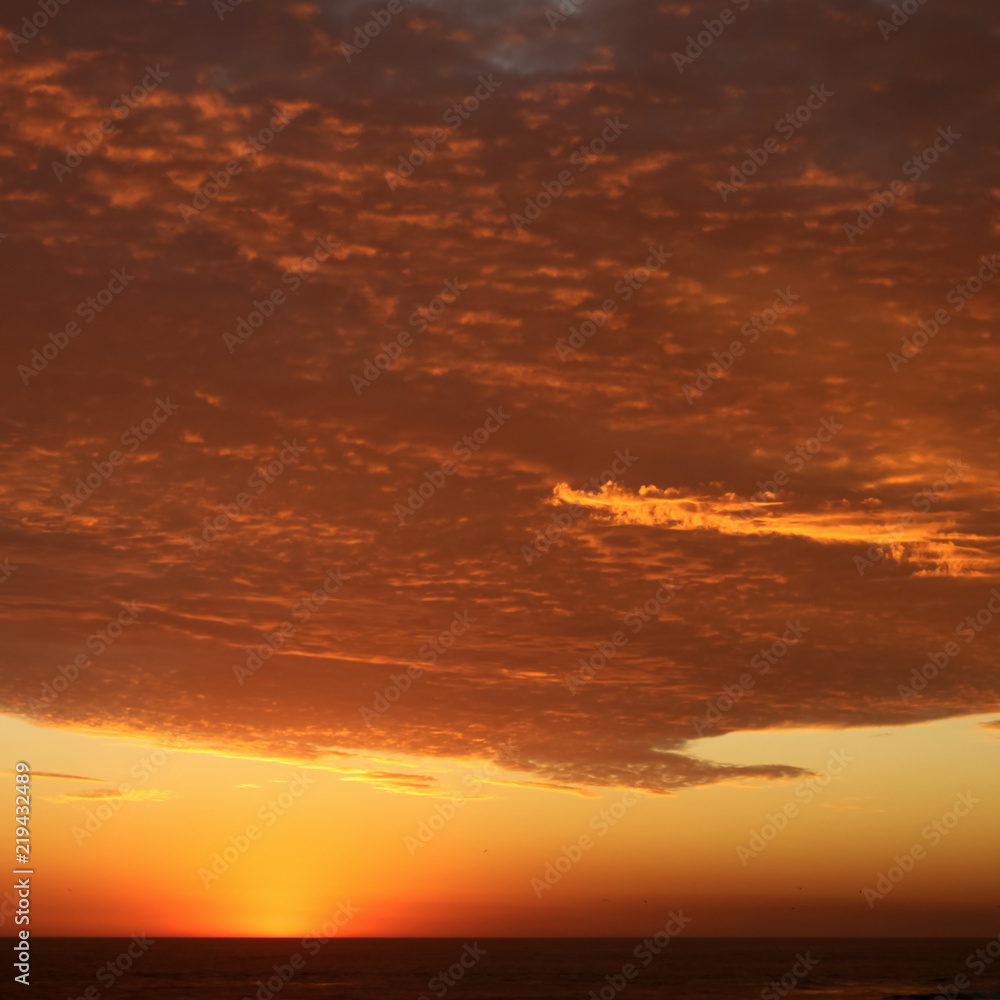 Fototapeta premium Dramatic Volcanic Crimson Sunset over Pacific Ocean