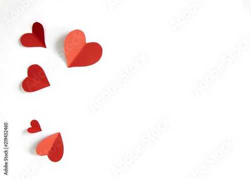 Red paper hearts on white