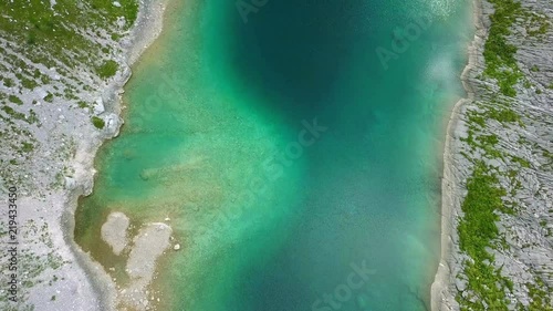 Aerial: Triglav national park in Slovenia, Seven lakes valley. Flying at Ledvica lake. Beautiful valley with lakes between high mountains.