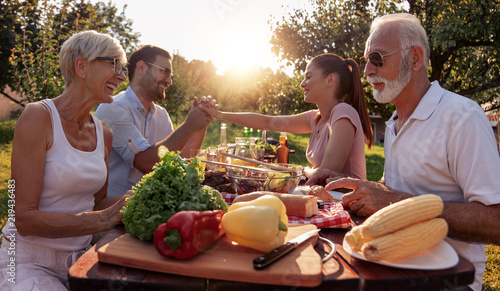 Family having barbecue party in backyard