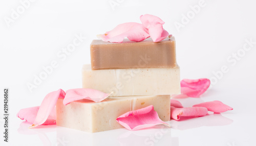 Handmade soap with flower petals on white background