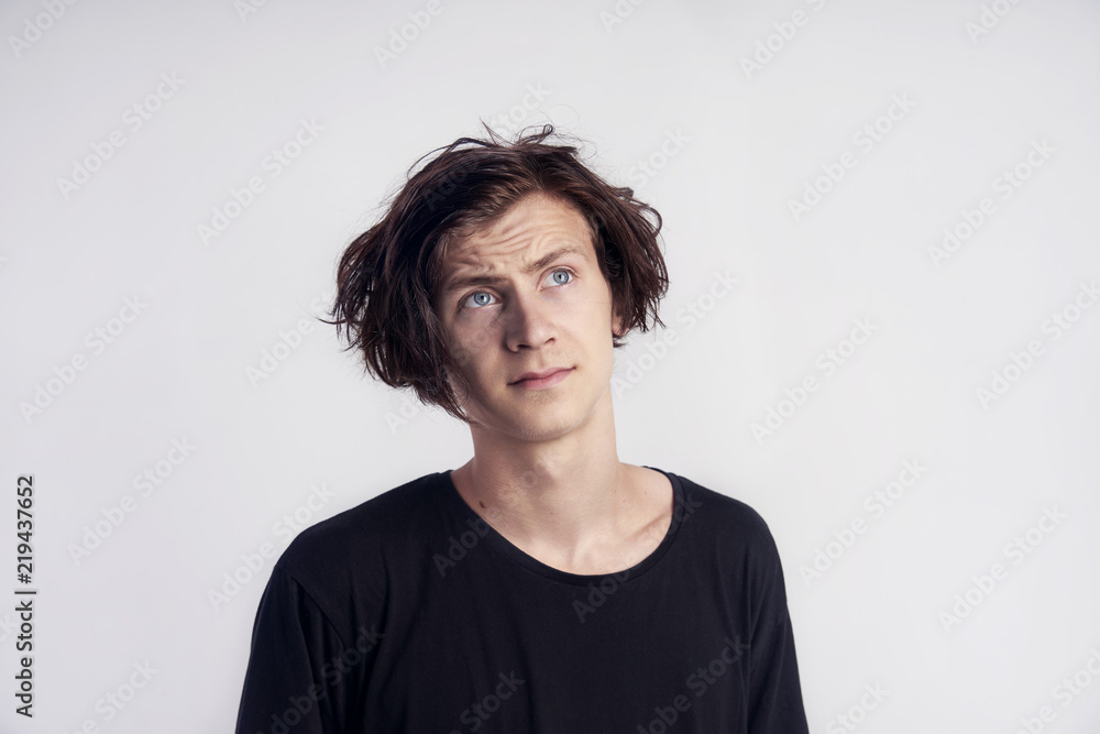 Portrait of young handsome hipster man look surprised disappointment, black t-shirt, white background.. Portrait of young handsome hipster man look surprised disappointment, black t-shirt, white background..
