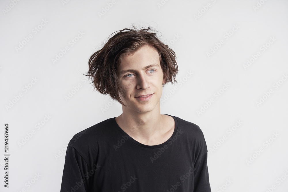Portrait of young handsome hipster man smiling, black t-shirt, white background. Portrait of young handsome hipster man smiling, black t-shirt, white background.