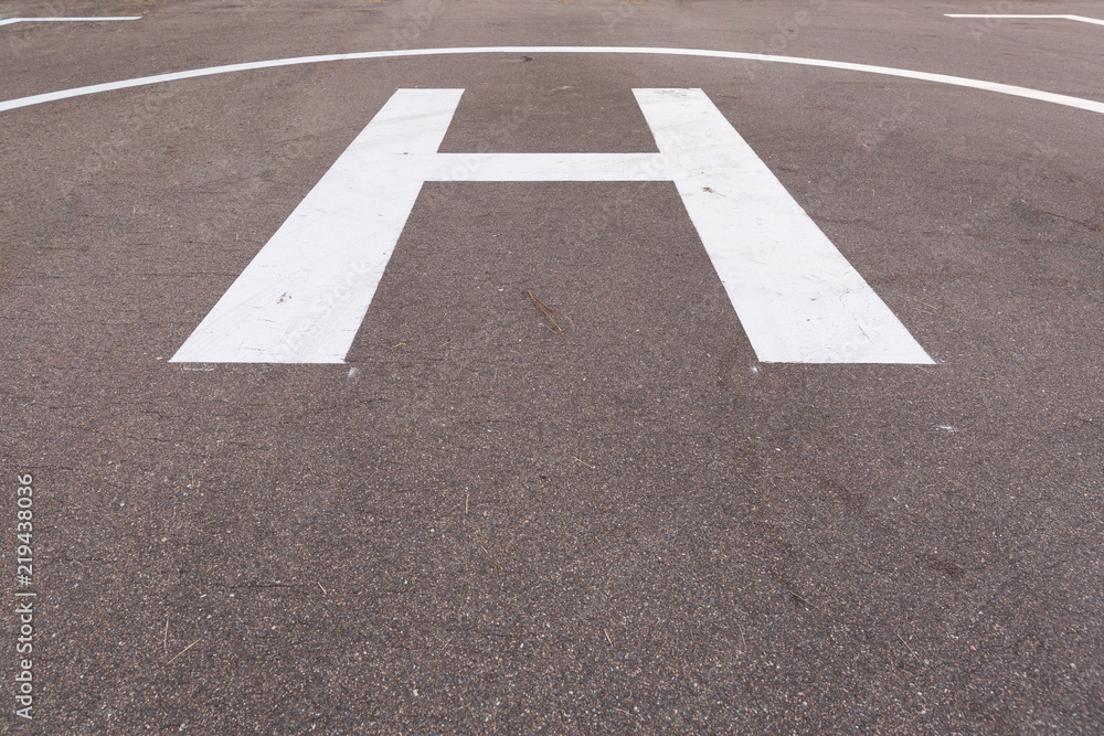 Closeup of helipad for landing helicopters on asphalt ground Closeup of helipad for landing helicopters on asphalt ground