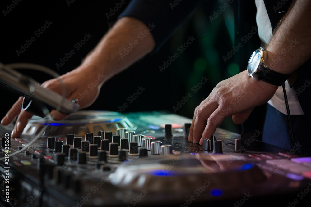Closeup of DJ's hands mixing music at disco Closeup of DJ's hands mixing music at disco