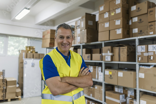 Smiling mature man working in a warehouse.