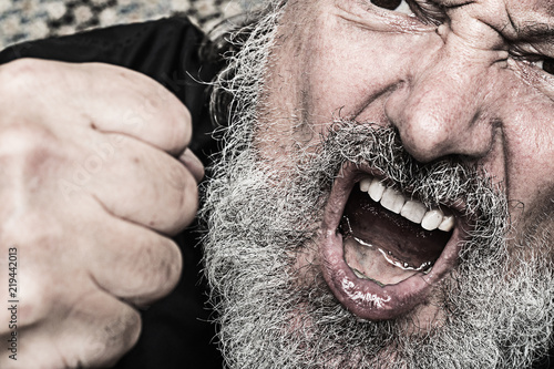  aggressive crying man with a clenched fist, open mouth snd  grey full beard