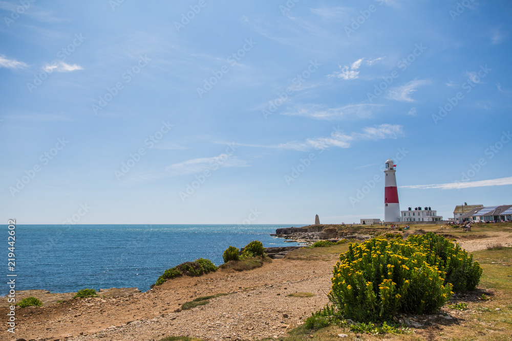 Portland Bill Lighthouse on a Bright Sunny Day with Blue Sky and Sea.