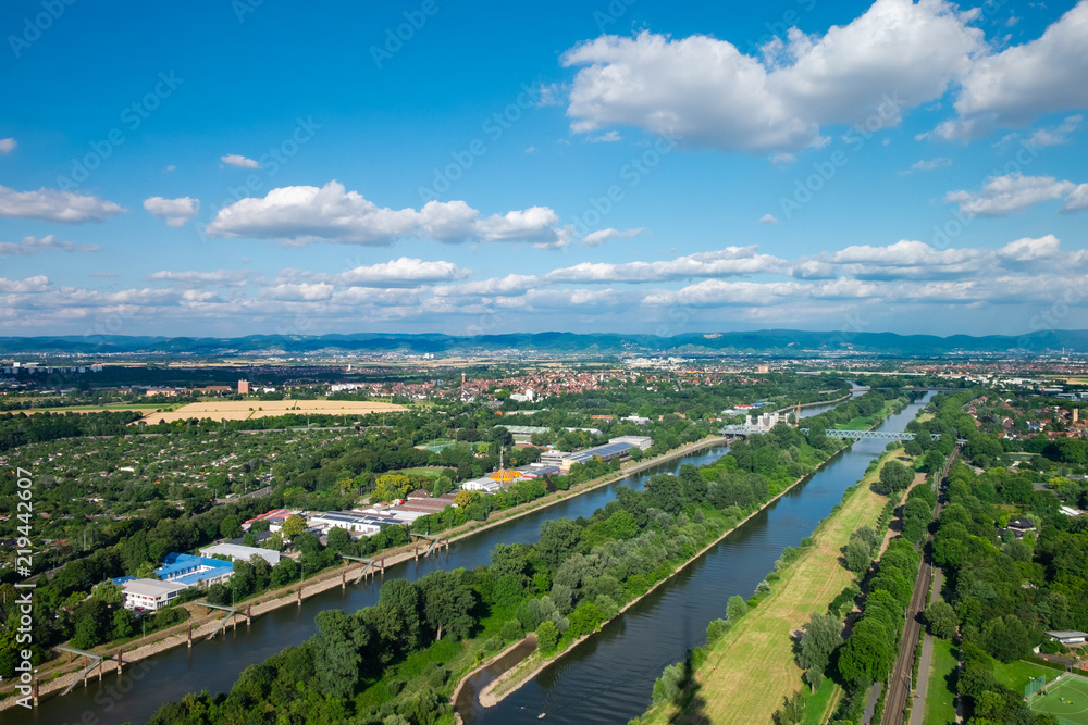 The aerial view of the area around Manheim city from above, with Neckar river in the center and hills in the background. Shot on a sunny summer day from the telecommunication tower.