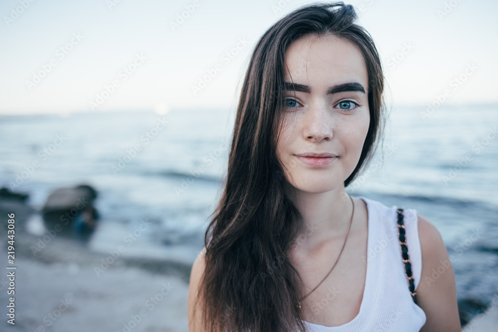 Pretty teen girl on the background of blue sea Pretty teen girl on the background of blue sea