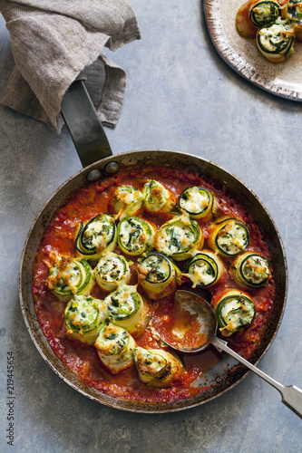 Courgette stuffed with ricotta, spinach and peas in tomato sauce photo