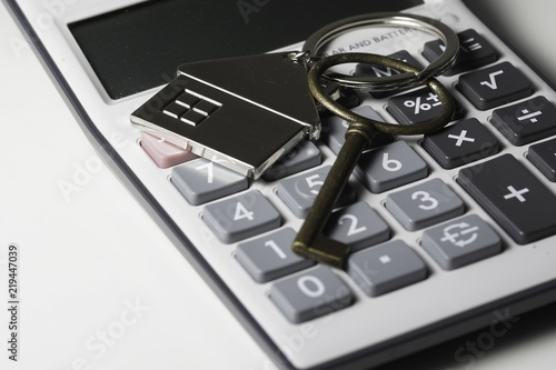 House key chain, bronze key  and calculator