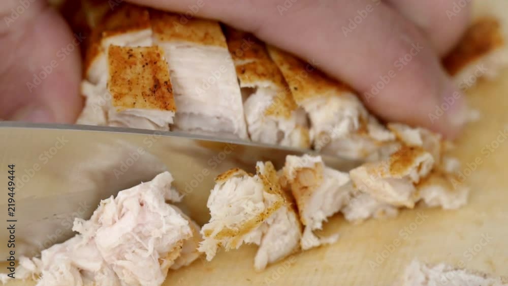 Cook chops the baked turkey meat in a slow motion Cook chops the baked turkey meat in a slow motion