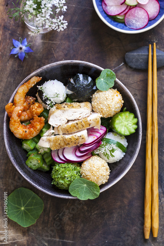 Bento box with onigiri, prawns and vegetables