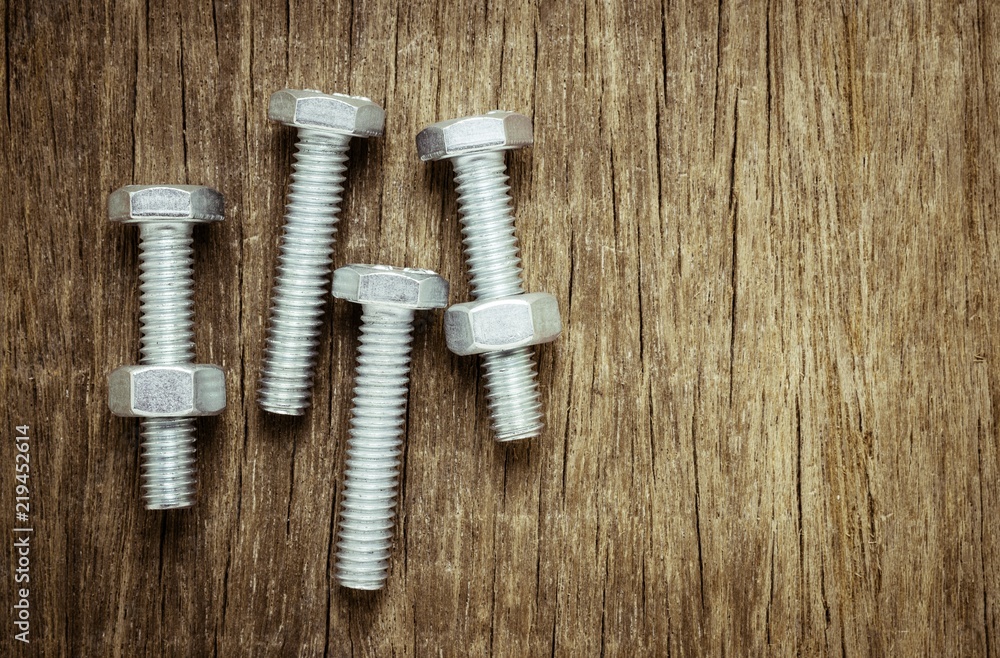 Fototapeta premium nuts and bolts on abandoned wood desk.