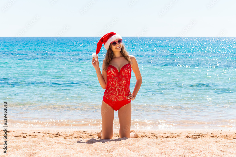 christmas holiday vacation at the beach. girl in santa hat on the sea christmas holiday vacation at the beach. girl in santa hat on the sea