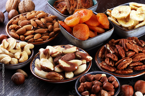 dried fruits and assorted nuts composition on rustic table