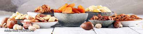 dried fruits and assorted nuts composition on rustic table photo