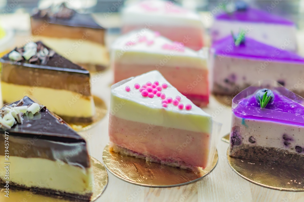 Pastry shop display window with variety of cheesecakes, selective focus Pastry shop display window with variety of cheesecakes, selective focus
