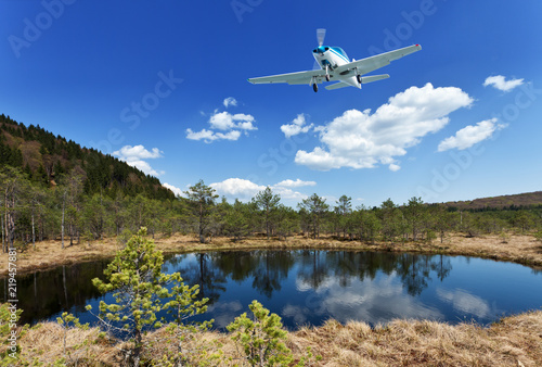 Exploring the wilderness - small aircraft flying above scenic view