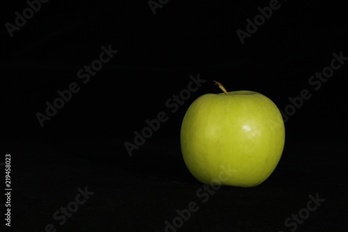 Single or group of apples including granny smith, golden delicious and royal gala on a black background.