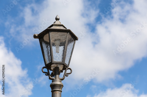 street lantern light with blue sky and clouds © Nicole Lienemann