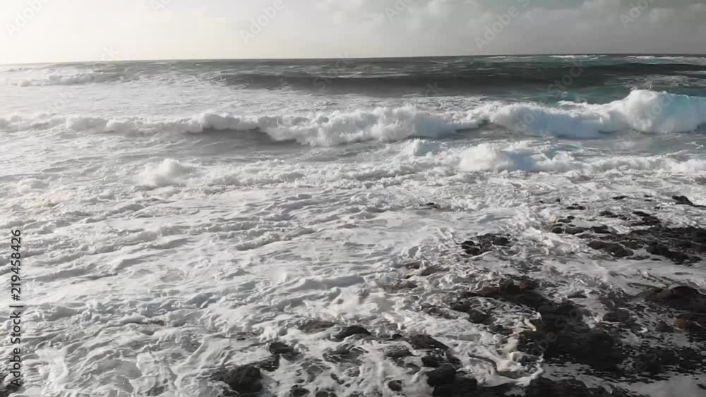 Waves crash on beach, slow motion aerial Waves crash on beach, slow motion aerial