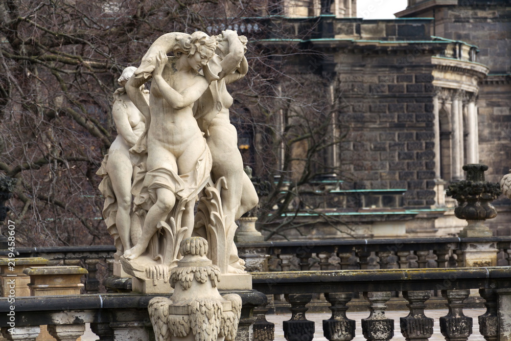 Statues around Nymphenbad at baroque Zwinger palace in Dresden, Germany, sunny spring day