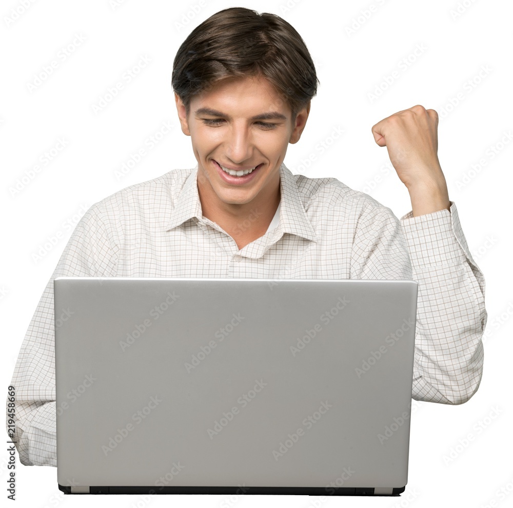 Portrait of Young Man Using Laptop with Fist Raised Portrait of Young Man Using Laptop with Fist Raised
