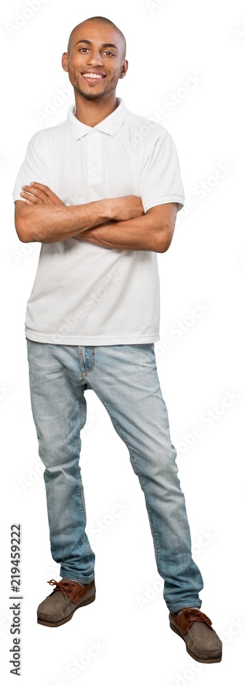 young man standing with arms crossed young man standing with arms crossed