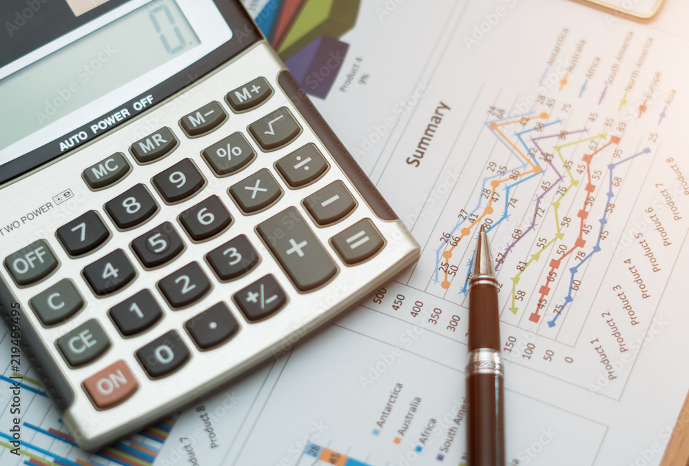 Top view,Close up business concept, Pen is on summary report and calculator on table office. Top view,Close up business concept, Pen is on summary report and calculator on table office.