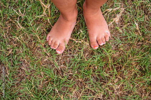 Bare feet of girl on the lawn