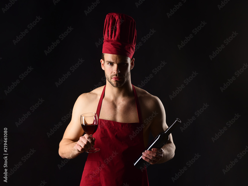 Restaurant. Wine making. Male sommelier tasting red wine. Chef or sommelier,  man in cook hat, apron.