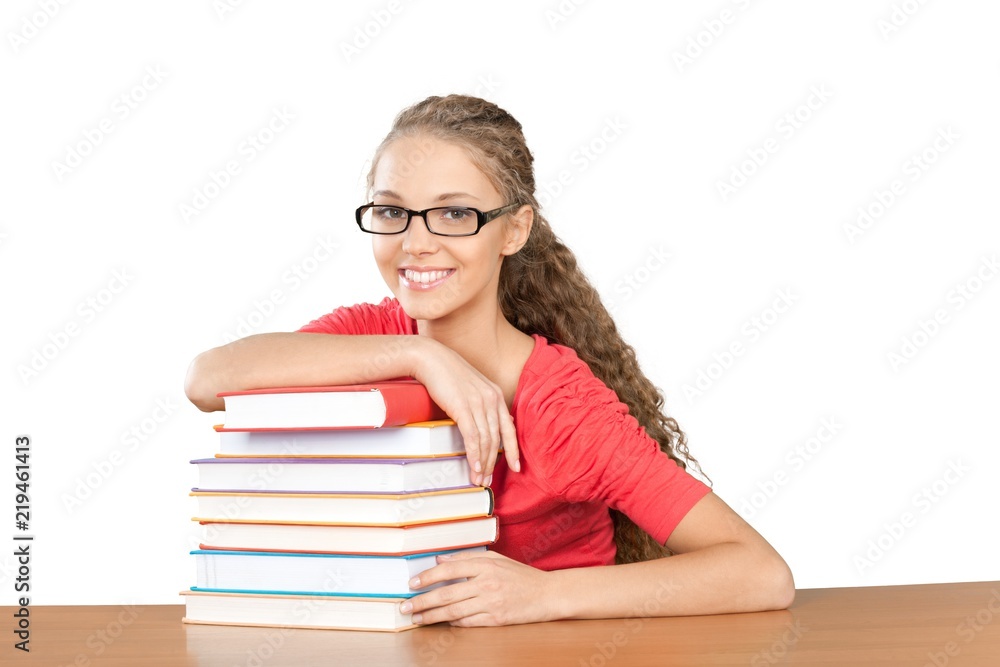 Friendly Young Girl Sitting Behind a Desk with a Books - Friendly Young Girl Sitting Behind a Desk with a Books -