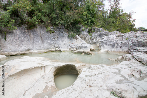 View of the Mirna riverbed in Kotli, Croatia. Locals and tourists bathe in the rinsed out waterholes. photo
